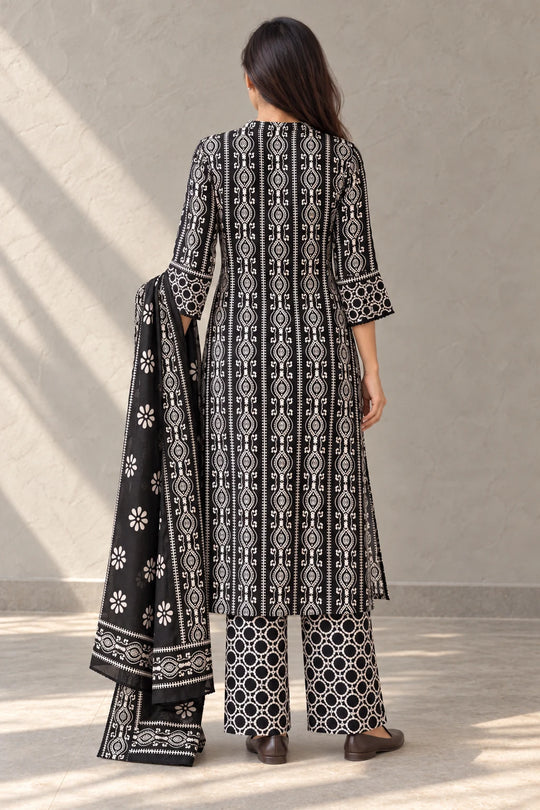 Back view of the black batik kurta set with the dupatta over one arm, detail