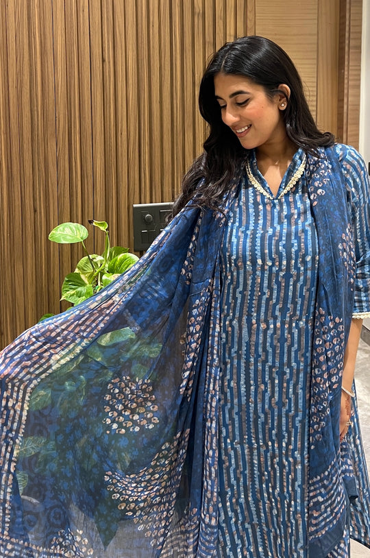 Woman smiling in a blue striped batik kurta set, dupatta draped forward