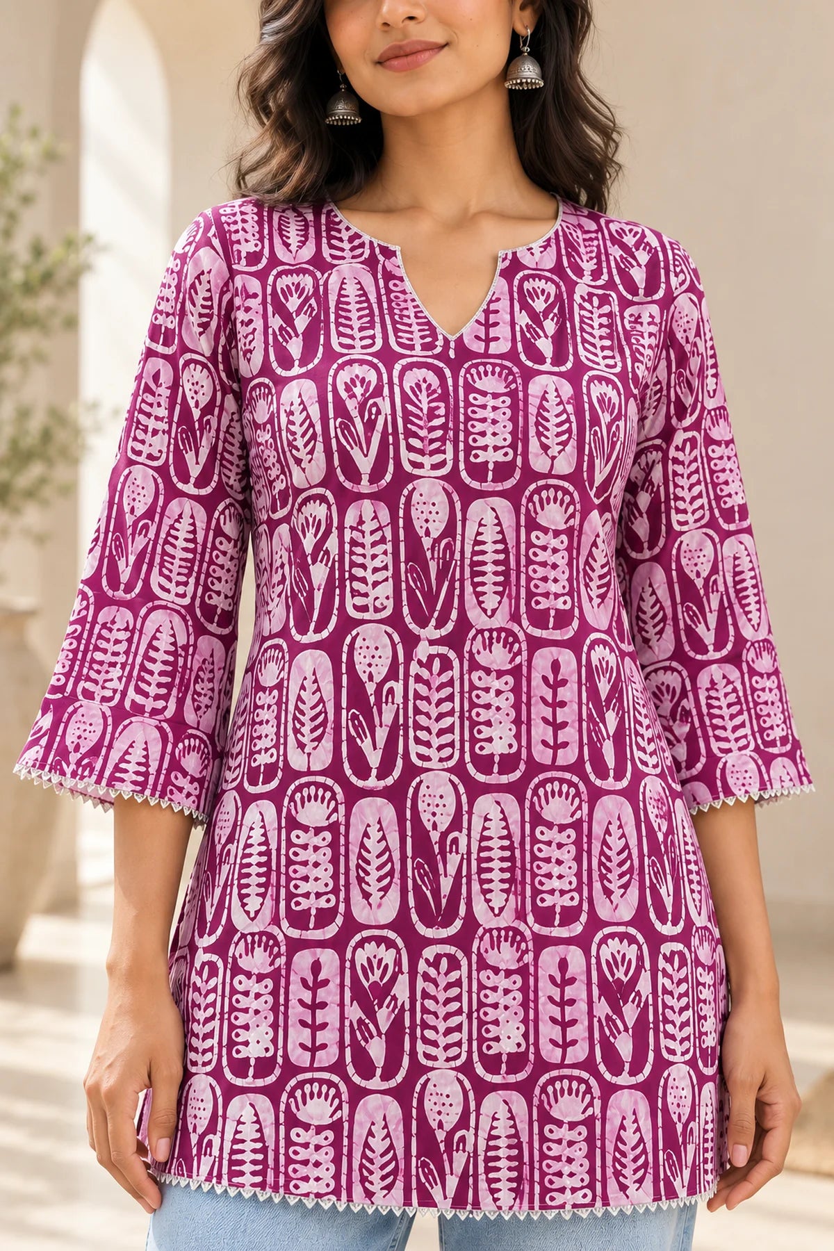 Wine batik tunic close-up showing notched neckline and bell sleeves