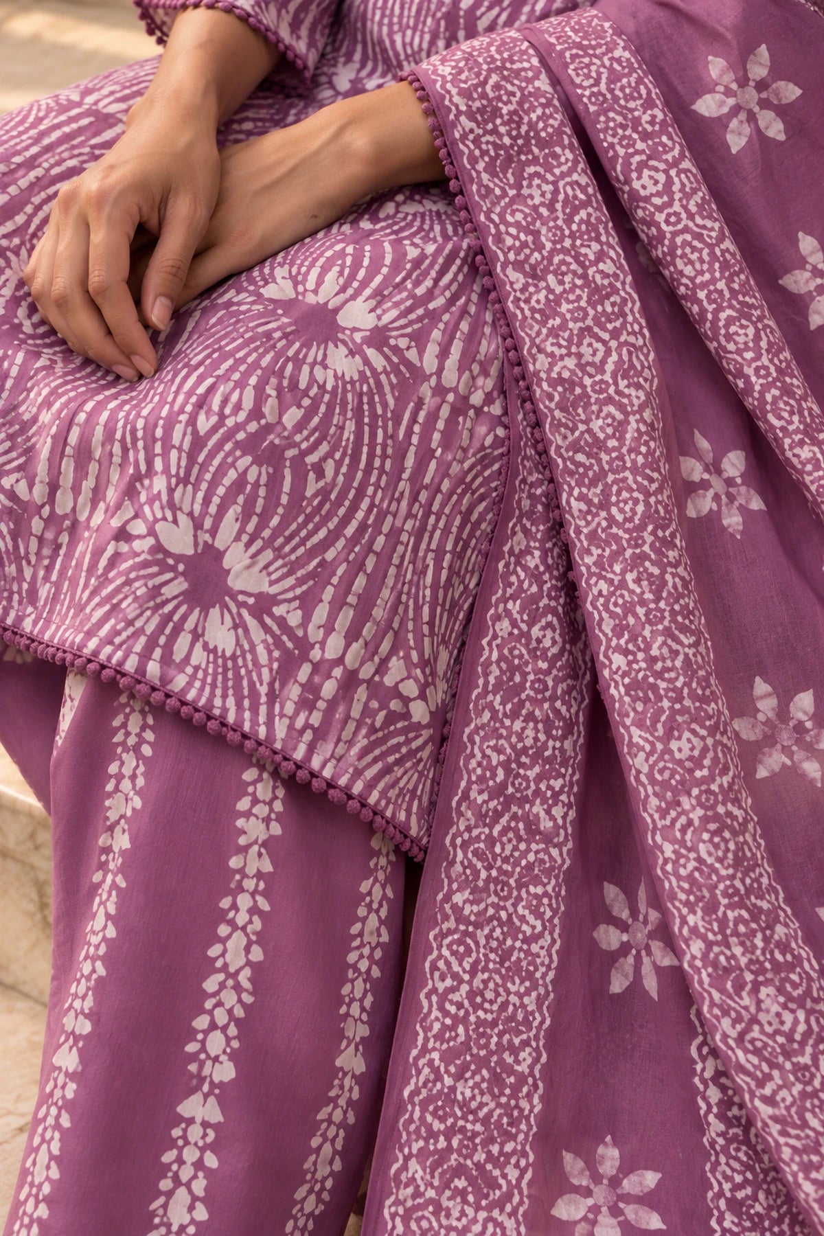 Lavender batik dupatta with flower motifs draped over the kurta