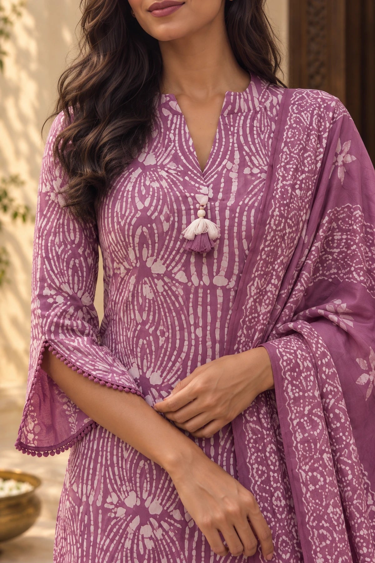 Close-up of the lavender kurta's mandarin collar and white tassel