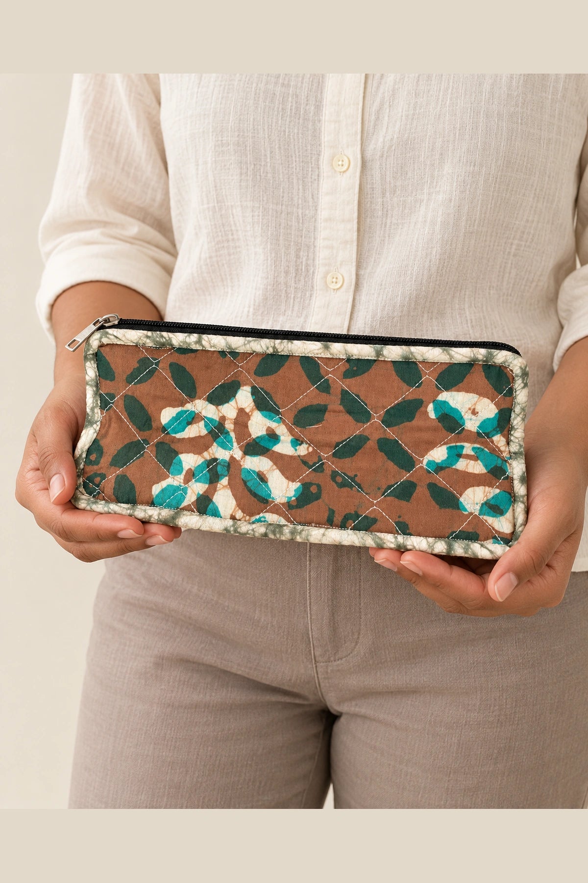 Quilted Batik Makeup Pouch in Brown Teal Leaf print – held in hand | Shades of You