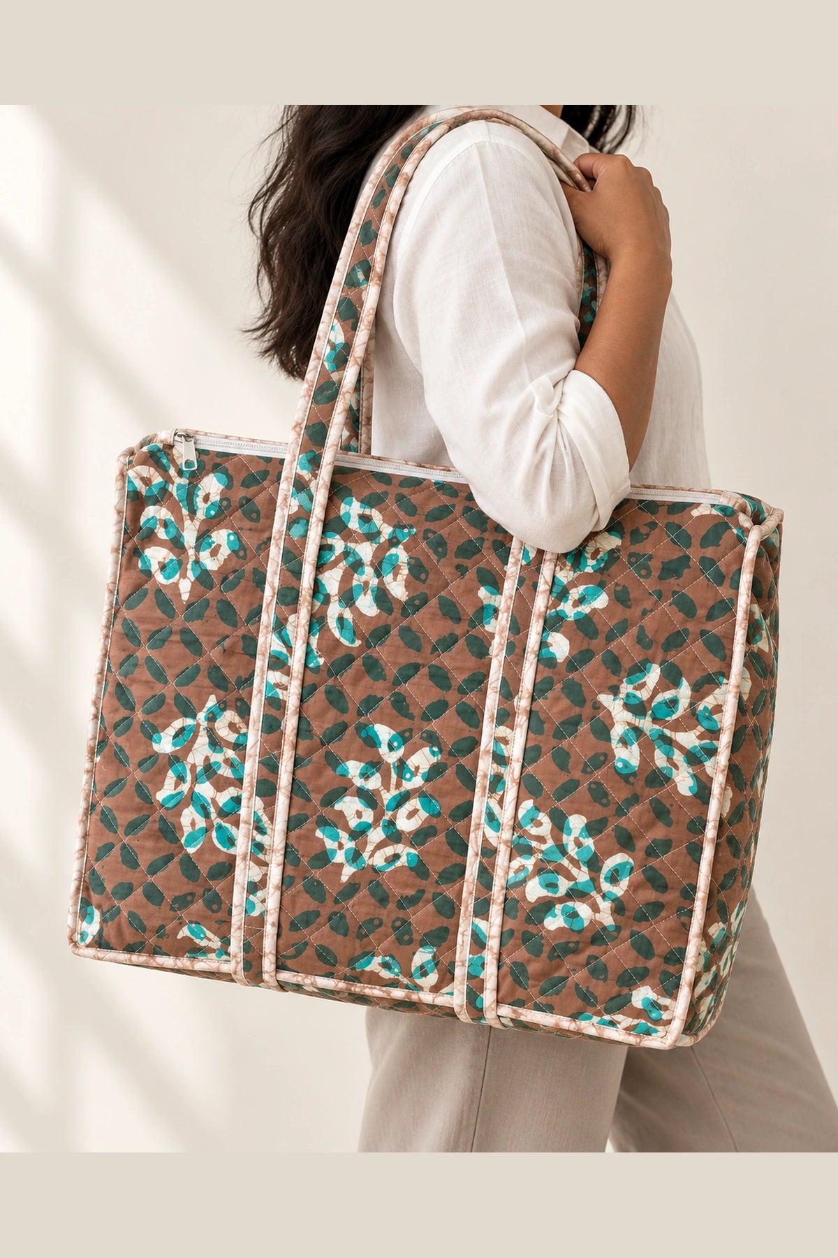 Quilted Batik Tote Bag in Brown Teal Leaf print – held in hand | Shades of You