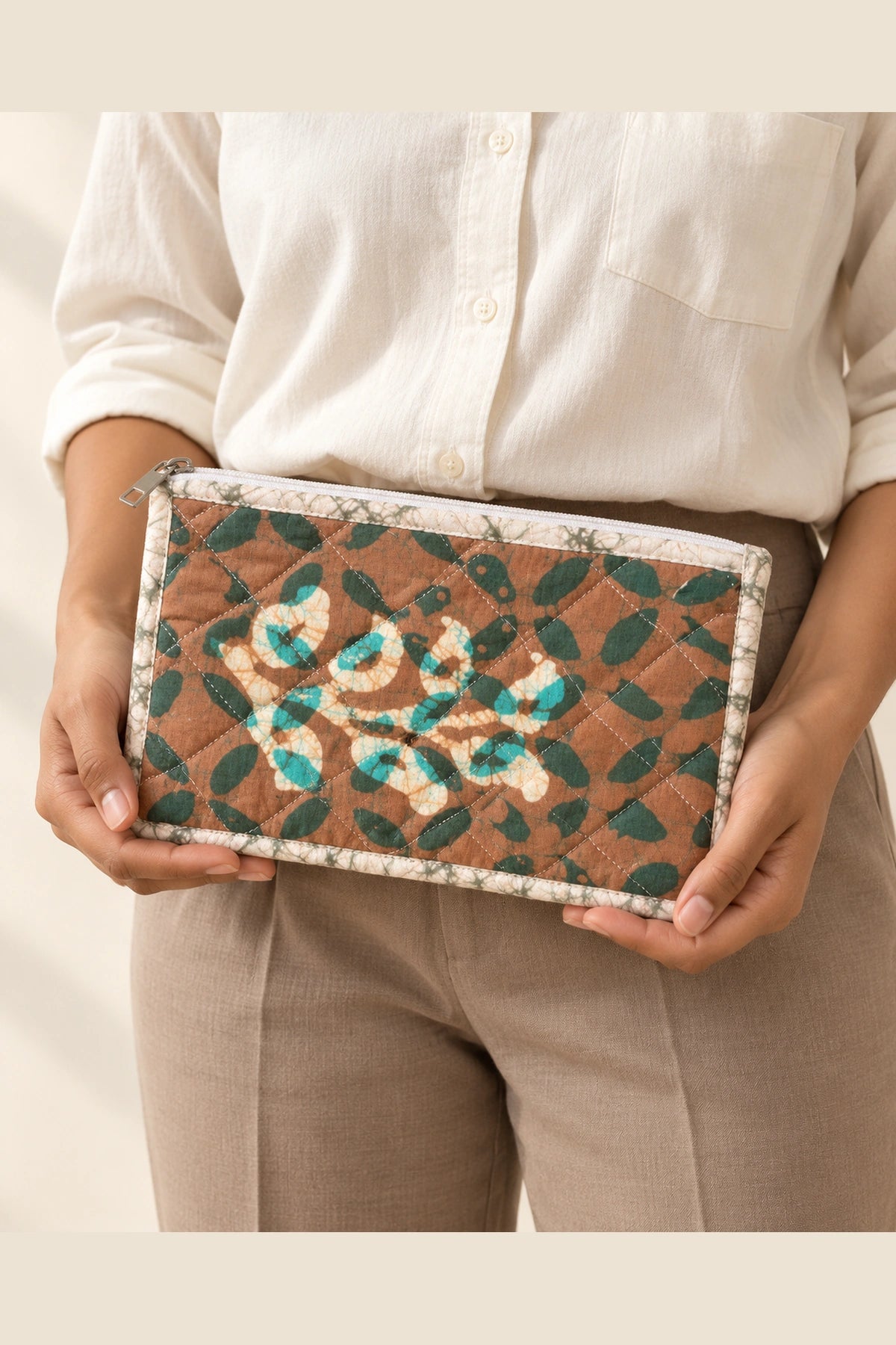 Quilted Batik Utility Pouch in Brown Teal Leaf print – held in hand | Shades of You
